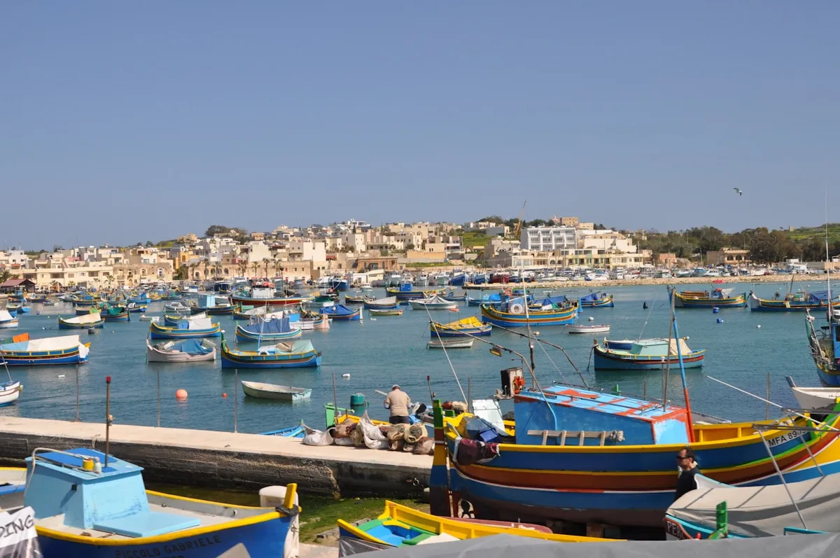 Colourful traditional luzzu fishing boats in Marsaxlokk harbour